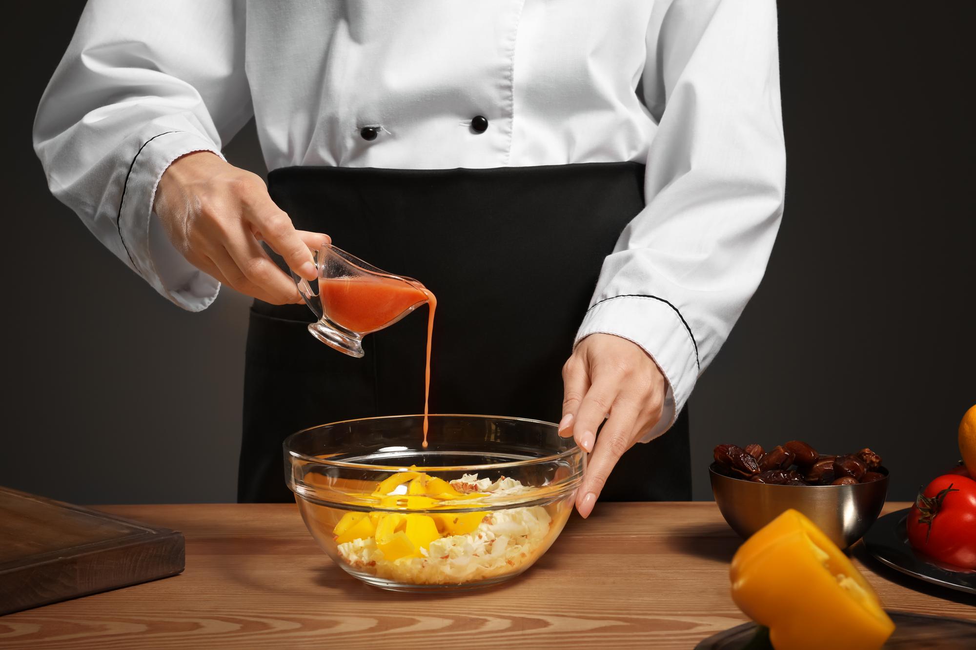 Chef hands finishing sauce